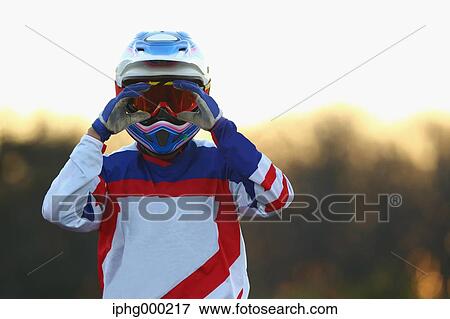 Stock Photo - Motocross biker on dirt track. Fotosearch