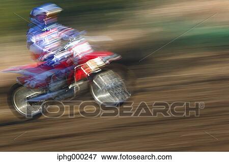 Stock Photo - Motocross biker on dirt track. Fotosearch
