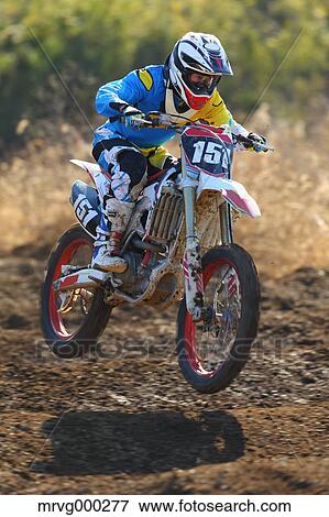 Motocross biker on dirt track View Large Photo Image Stock Photo - Motocross biker on dirt track. Fotosearch