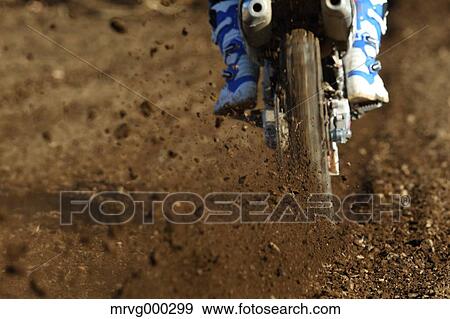 Stock Photo - Motocross biker on dirt track. Fotosearch