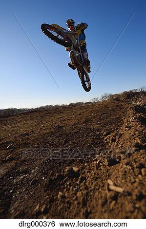 Motocross biker on dirt track View Large Photo Image Stock Photograph - Motocross biker on dirt track. Fotosearch