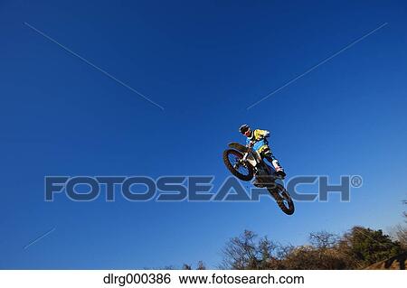 Motocross biker on dirt track View Large Photo Image Stock Photograph - Motocross biker on dirt track. Fotosearch
