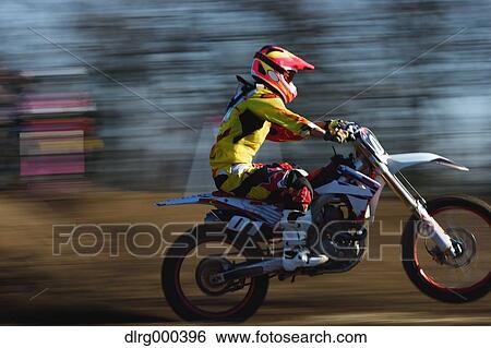 Motocross biker on dirt track View Large Photo Image Stock Photograph - Motocross biker on dirt track. Fotosearch