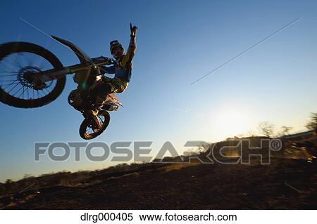 Stock Photography - Motocross biker on dirt track. Fotosearch