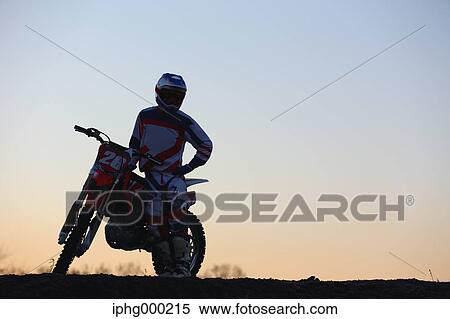 Stock Photography - Motocross biker on dirt track. Fotosearch