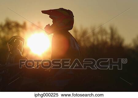 Stock Photography - Motocross biker on dirt track. Fotosearch