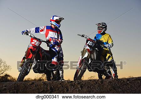 Motocross bikers on dirt track View Large Photo Image Stock Image - Motocross bikers on dirt track. Fotosearch