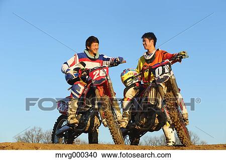 Motocross bikers on dirt track View Large Photo Image Stock Image - Motocross bikers on dirt track. Fotosearch