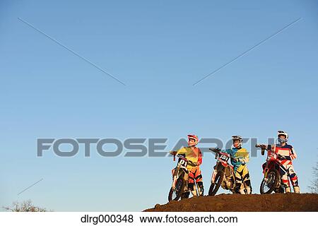 Motocross bikers on dirt track View Large Photo Image Stock Photo - Motocross bikers on dirt track. Fotosearch
