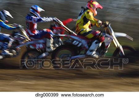 Stock Photo - Motocross bikers on dirt track. Fotosearch