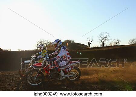 Motocross bikers on dirt track View Large Photo Image Stock Photo - Motocross bikers on dirt track. Fotosearch