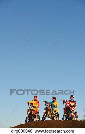 Stock Photograph - Motocross bikers on dirt track. Fotosearch