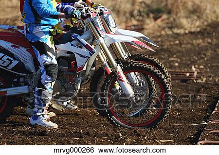 Motocross bikers on dirt track View Large Photo Image Stock Photograph - Motocross bikers on dirt track. Fotosearch