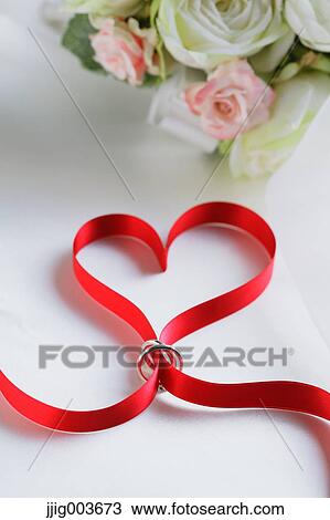 Red ribbon and wedding rings View Large Photo Image Stock Image - Red ribbon and wedding rings. Fotosearch