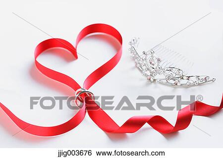 Red ribbon and wedding rings View Large Photo Image Stock Photograph - Red ribbon and wedding rings. Fotosearch