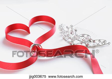 Red ribbon and wedding rings View Large Photo Image Stock Photography - Red ribbon and wedding rings. Fotosearch