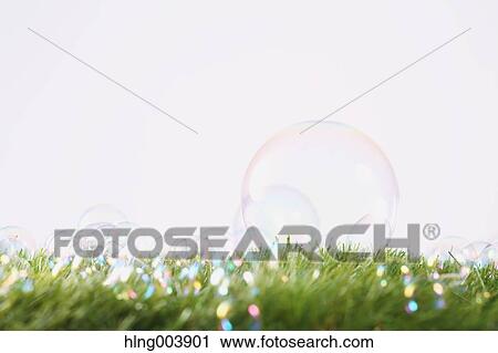 Stock Image - Soap bubbles on grass. Fotosearch