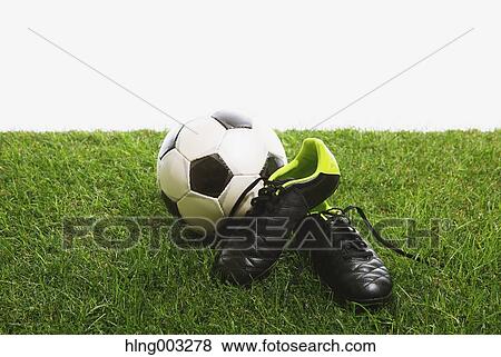 Soccer ball and shoes on grass View Large Photo Image Stock Photo - Soccer ball and shoes on grass. Fotosearch