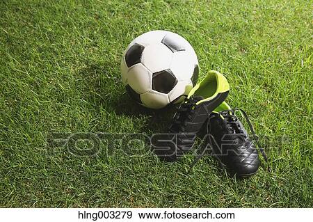 Soccer ball and shoes on grass View Large Photo Image Stock Photo - Soccer ball and shoes on grass. Fotosearch