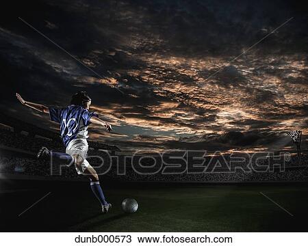 Stock Image - Soccer player in dramatic action. Fotosearch