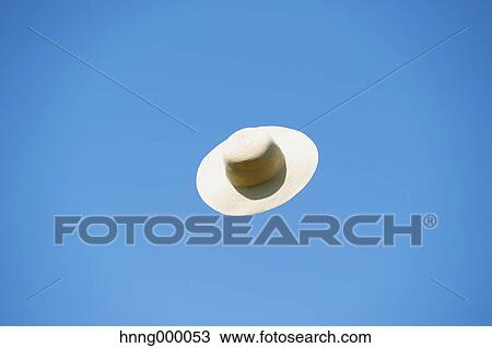 Straw hat flying in the sky View Large Photo Image Stock Image - Straw hat flying in the sky. Fotosearch