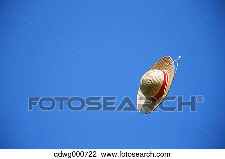 Straw hat flying in the sky View Large Photo Image Stock Image - Straw hat flying in the sky. Fotosearch