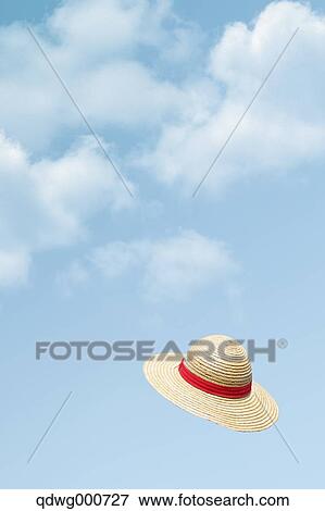 Straw hat flying in the sky View Large Photo Image Stock Photo - Straw hat flying in the sky. Fotosearch