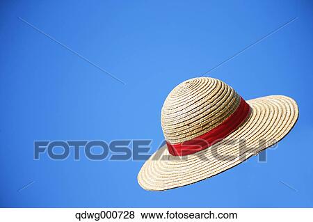 Straw hat flying in the sky View Large Photo Image Stock Photo - Straw hat flying in the sky. Fotosearch