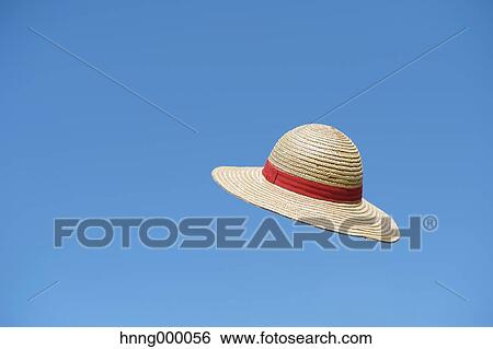 Straw hat flying in the sky View Large Photo Image Stock Photograph - Straw hat flying in the sky. Fotosearch