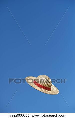 Straw hat flying in the sky View Large Photo Image Stock Photography - Straw hat flying in the sky. Fotosearch
