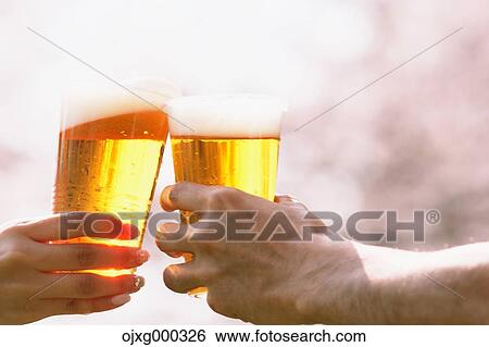Toasting with beer under the cherry blossoms View Large Photo Image Stock Photograph - Toasting with beer under the cherry blossoms. Fotosearch