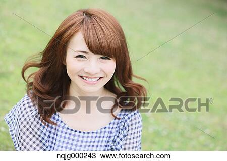 Young attractive Japanese woman in a city park View Large Photo Image Stock Image - Young attractive Japanese woman in a city park. Fotosearch