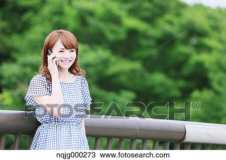 Young attractive Japanese woman in a city park View Large Photo Image Stock Image - Young attractive Japanese woman in a city park. Fotosearch