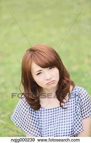 Young attractive Japanese woman in a city park View Large Photo Image Stock Photo - Young attractive Japanese woman in a city park. Fotosearch