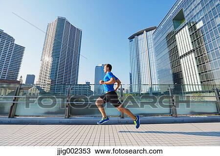 Young Caucasian man running in metropolitan area View Large Photo Image Stock Image - Young Caucasian man running in metropolitan area. Fotosearch