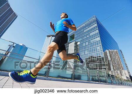 Young Caucasian man running in metropolitan area View Large Photo Image Stock Photograph - Young Caucasian man running in metropolitan area. Fotosearch