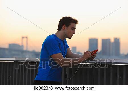 Young Caucasian man wearing sport clothes in metropolitan area View Large Photo Image Stock Photo - Young Caucasian man wearing sport clothes in metropolitan area. Fotosearch