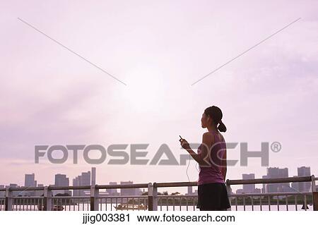 Young Japanese with smartphone during her run downtown Tokyo View Large Photo Image Stock Image - Young Japanese with smartphone during her run downtown Tokyo. Fotosearch