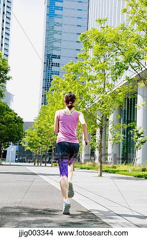 Young Japanese woman running downtown Tokyo View Large Photo Image Picture - Young Japanese woman running downtown Tokyo. Fotosearch