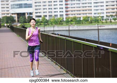 Young Japanese woman running downtown Tokyo View Large Photo Image Picture - Young Japanese woman running downtown Tokyo. Fotosearch