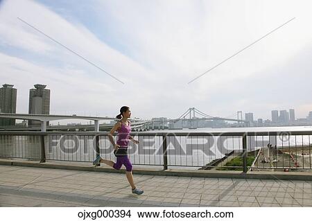 Young Japanese woman running downtown Tokyo View Large Photo Image Picture - Young Japanese woman running downtown Tokyo. Fotosearch