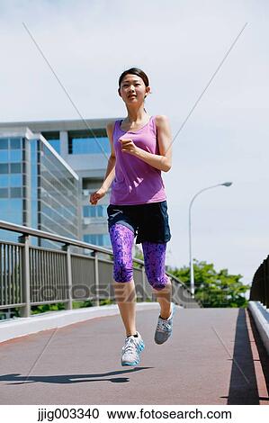 Young Japanese woman running downtown Tokyo View Large Photo Image Stock Image - Young Japanese woman running downtown Tokyo. Fotosearch