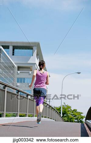 Young Japanese woman running downtown Tokyo View Large Photo Image Stock Image - Young Japanese woman running downtown Tokyo. Fotosearch