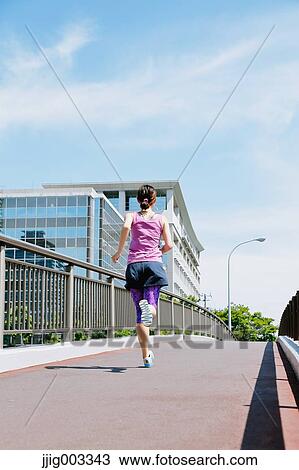 Young Japanese woman running downtown Tokyo View Large Photo Image Stock Image - Young Japanese woman running downtown Tokyo. Fotosearch