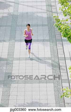 Young Japanese woman running downtown Tokyo View Large Photo Image Stock Image - Young Japanese woman running downtown Tokyo. Fotosearch