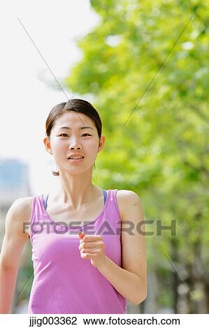 Young Japanese woman running downtown Tokyo View Large Photo Image Stock Image - Young Japanese woman running downtown Tokyo. Fotosearch