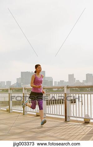 Young Japanese woman running downtown Tokyo View Large Photo Image Stock Image - Young Japanese woman running downtown Tokyo. Fotosearch