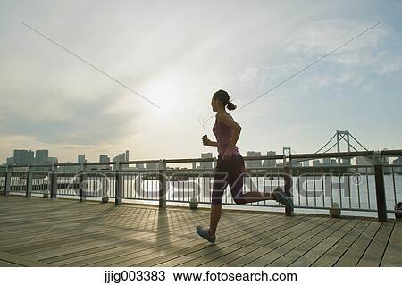 Young Japanese woman running downtown Tokyo View Large Photo Image Stock Image - Young Japanese woman running downtown Tokyo. Fotosearch