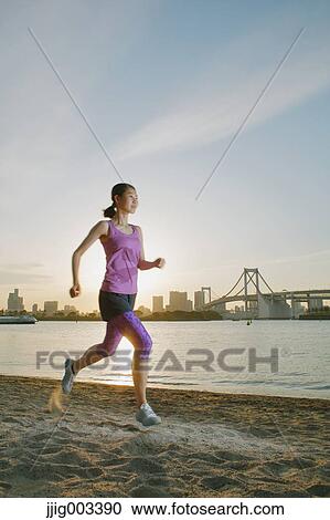 Young Japanese woman running downtown Tokyo View Large Photo Image Stock Image - Young Japanese woman running downtown Tokyo. Fotosearch