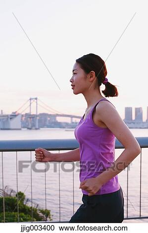 Young Japanese woman running downtown Tokyo View Large Photo Image Stock Image - Young Japanese woman running downtown Tokyo. Fotosearch